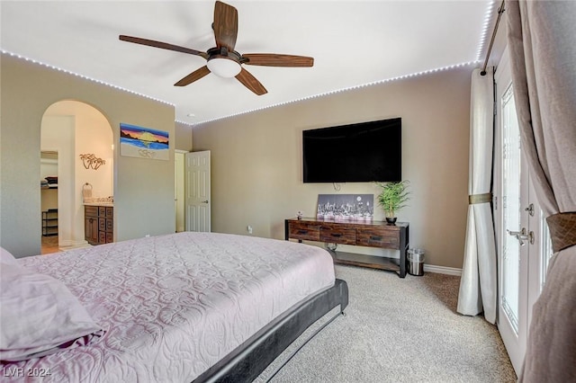 carpeted bedroom featuring ensuite bath and ceiling fan