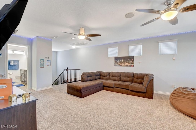 living room featuring carpet flooring, ceiling fan, and a wealth of natural light