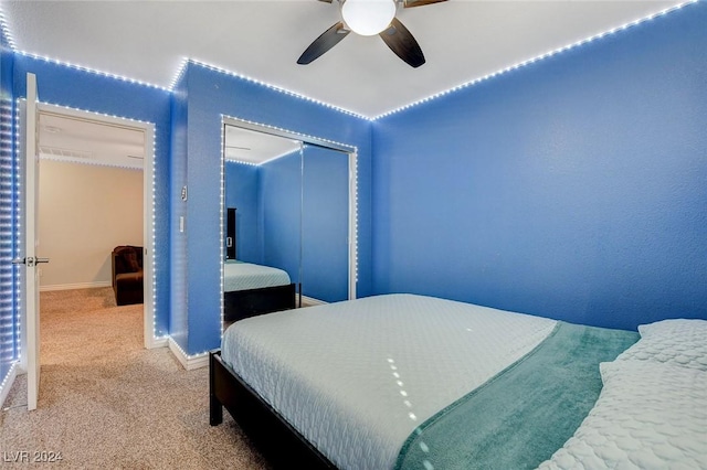 bedroom with carpet flooring, ceiling fan, and a closet