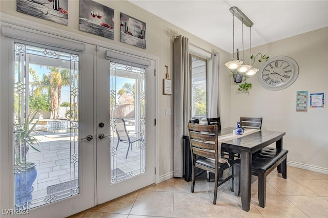 dining room featuring french doors and light tile patterned flooring