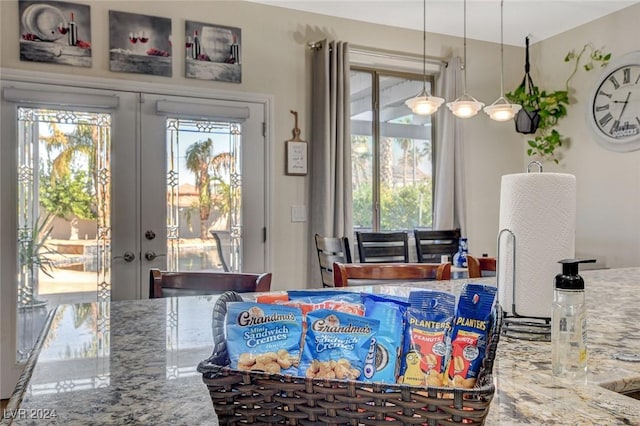 dining space featuring plenty of natural light and french doors