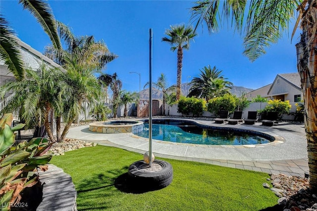 view of pool with a patio area, an in ground hot tub, and a yard