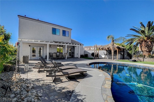 view of pool featuring a patio area and french doors