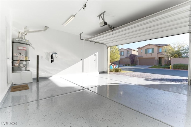 garage featuring strapped water heater and a garage door opener