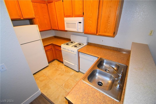 kitchen with white appliances and sink