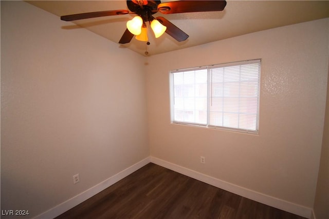 spare room with dark hardwood / wood-style flooring and ceiling fan