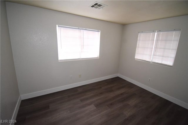 spare room featuring dark hardwood / wood-style floors