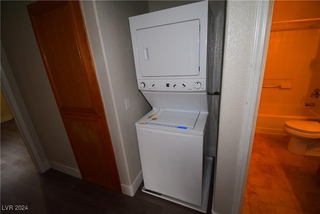 laundry area featuring stacked washer / drying machine