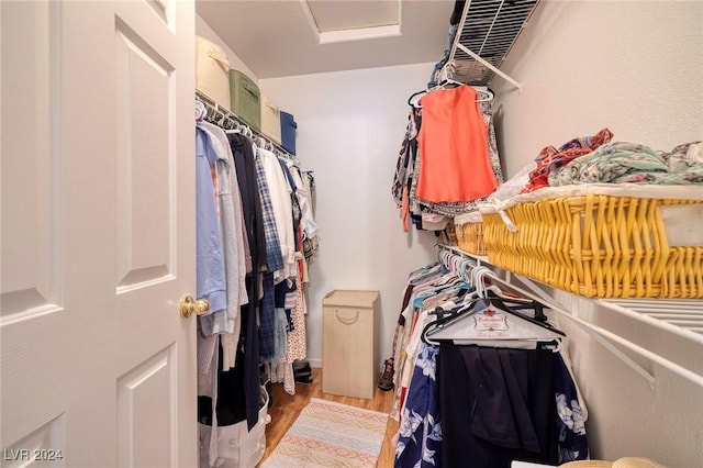 walk in closet featuring light hardwood / wood-style flooring