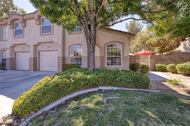 mediterranean / spanish-style house with a garage