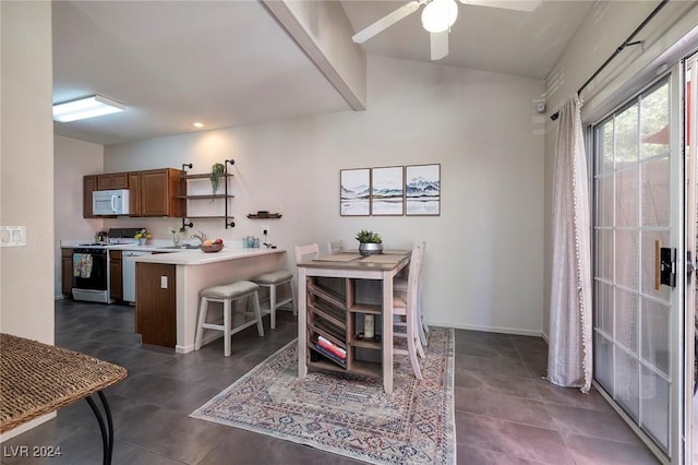 dining area with ceiling fan and sink