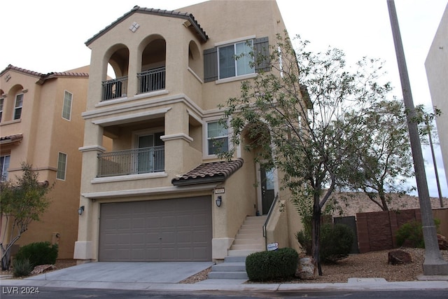 view of front facade featuring a garage and a balcony