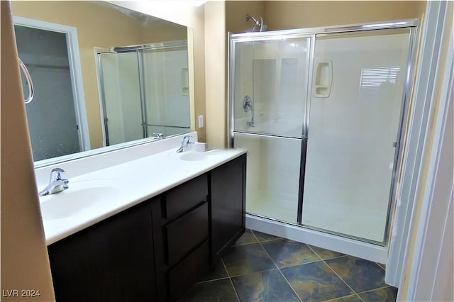 bathroom featuring vanity and a shower with shower door