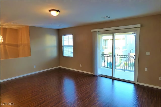 empty room with dark wood-type flooring