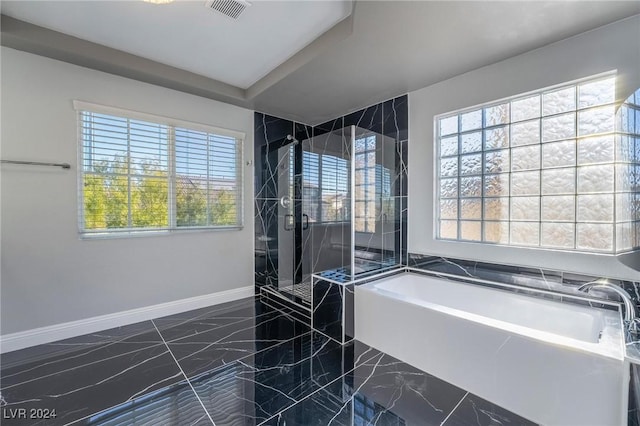 bathroom with shower with separate bathtub