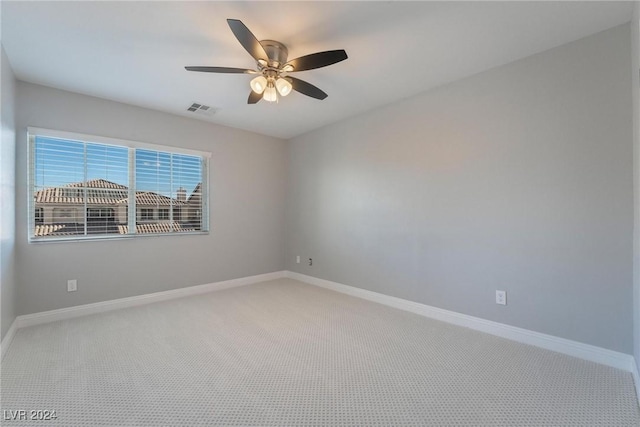 spare room featuring carpet floors and ceiling fan