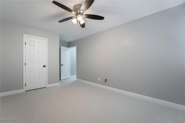 unfurnished bedroom with ceiling fan and light colored carpet