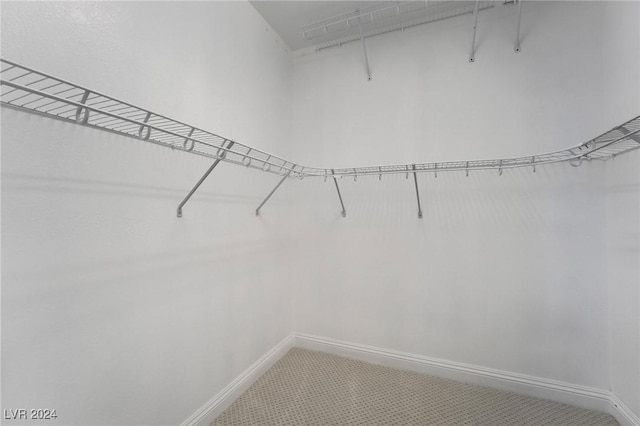 spacious closet with tile patterned floors