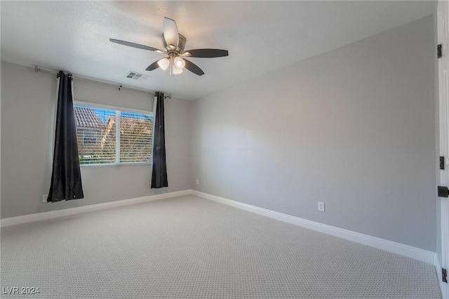 empty room with ceiling fan and carpet