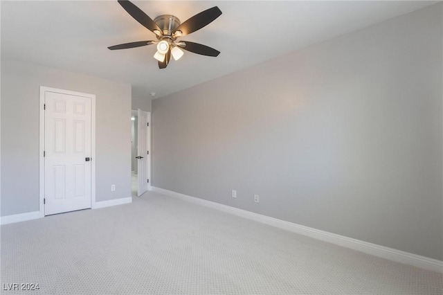 carpeted empty room featuring ceiling fan