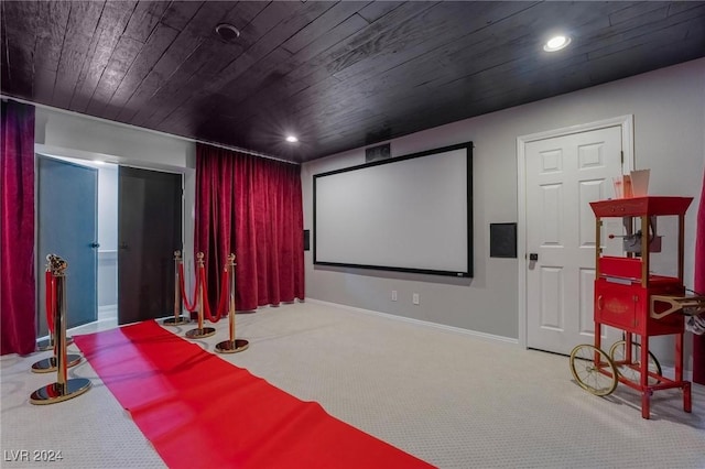 home theater with wooden ceiling and light carpet