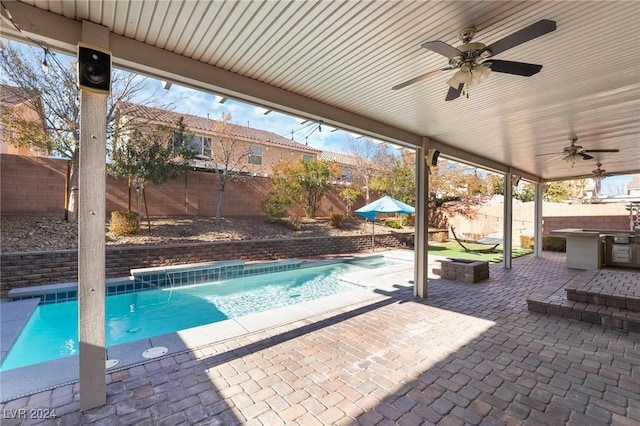 view of swimming pool featuring a patio and ceiling fan