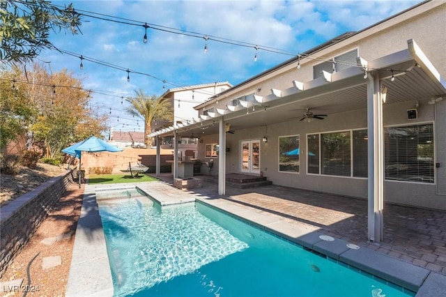 view of pool with a patio area and ceiling fan