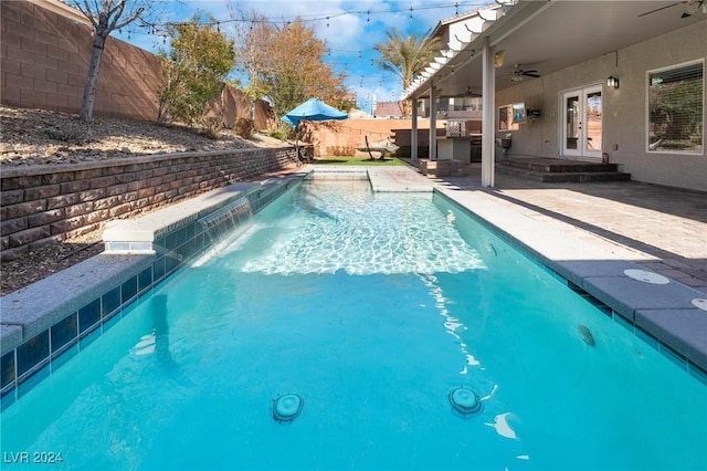 view of pool with ceiling fan, a patio, french doors, and pool water feature