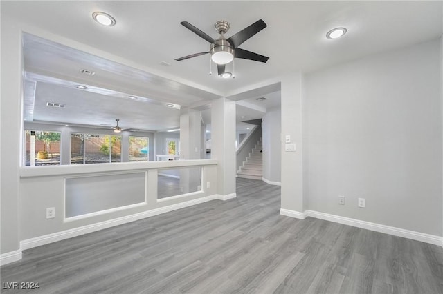 unfurnished living room with ceiling fan and hardwood / wood-style flooring