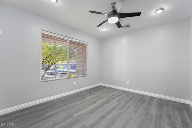 unfurnished room with ceiling fan and dark wood-type flooring