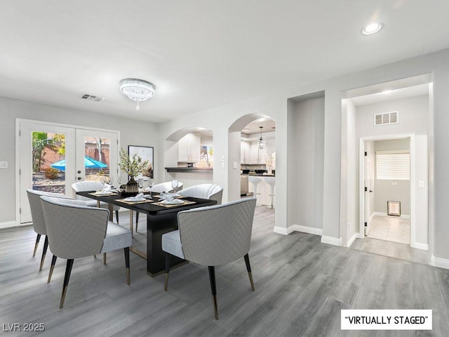 dining space with french doors and hardwood / wood-style floors