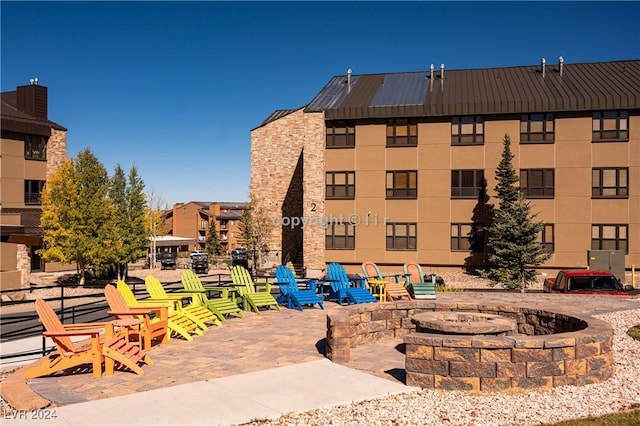 view of building exterior with an outdoor fire pit