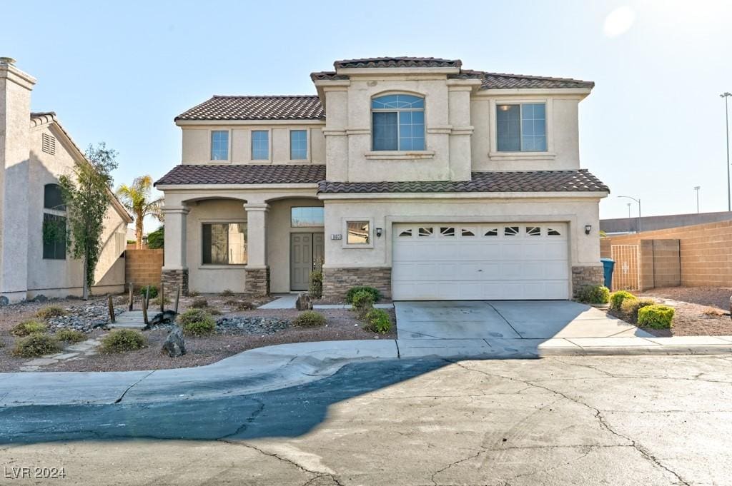 mediterranean / spanish house with a garage