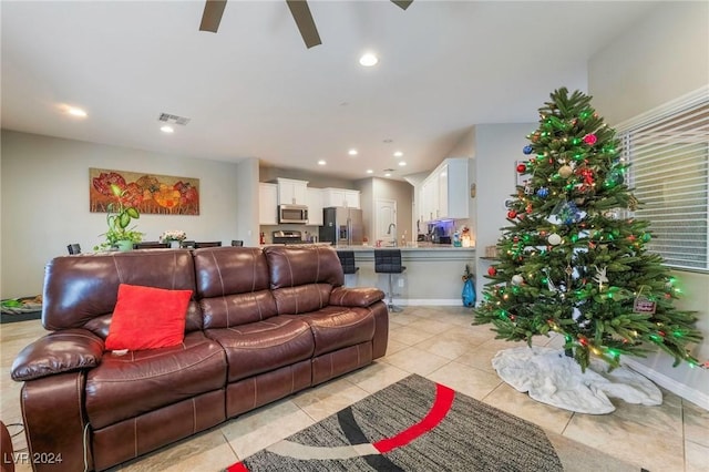 living room featuring light tile patterned floors and ceiling fan