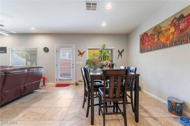 dining area with ceiling fan, light tile patterned floors, and a healthy amount of sunlight