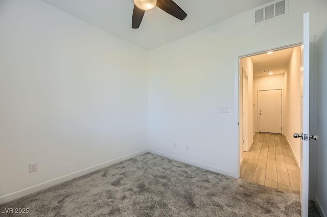 carpeted empty room featuring ceiling fan