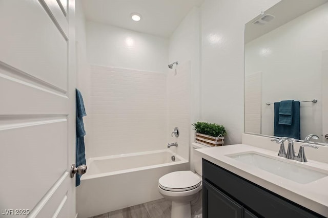 full bathroom with bathtub / shower combination, toilet, vanity, and hardwood / wood-style floors