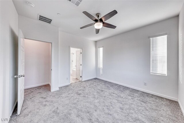 unfurnished bedroom with carpet floors, visible vents, and baseboards