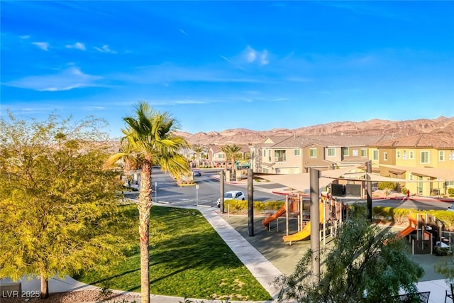 view of community with a residential view, playground community, and a mountain view