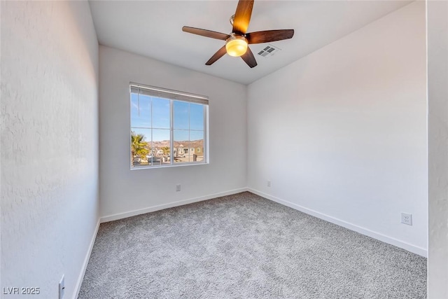 unfurnished room with baseboards, carpet flooring, visible vents, and a ceiling fan