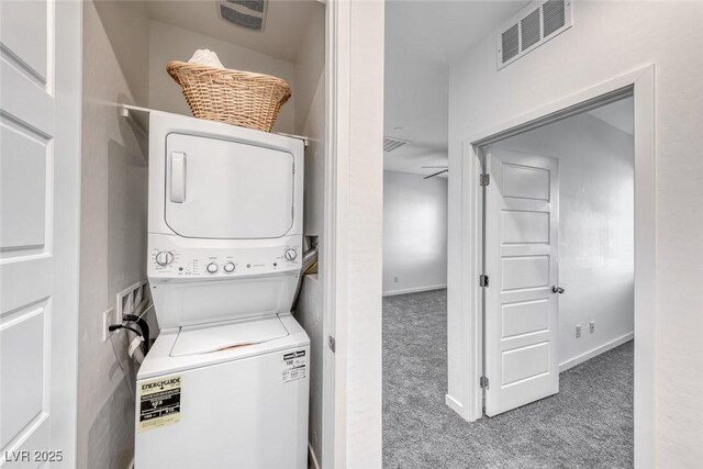 clothes washing area featuring laundry area, carpet floors, stacked washer and dryer, and visible vents