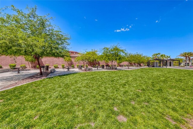 view of yard featuring a patio area, fence, and a pergola