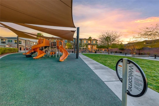 playground at dusk with playground community and a lawn