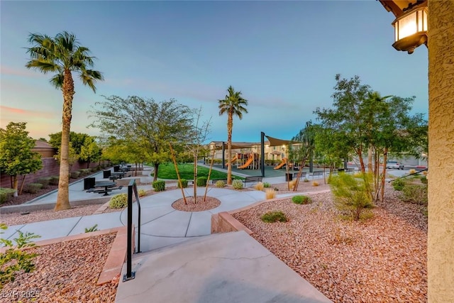 surrounding community featuring a patio area and playground community