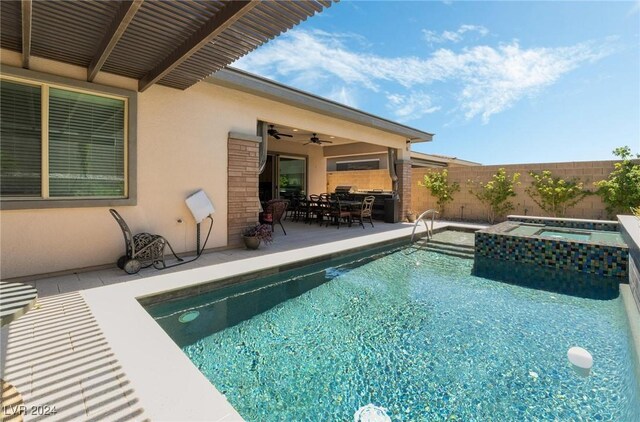 view of pool with an in ground hot tub, a patio area, and ceiling fan