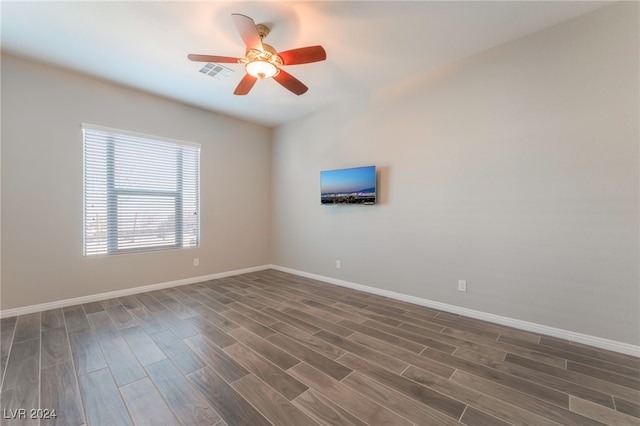 unfurnished room with ceiling fan and dark hardwood / wood-style floors