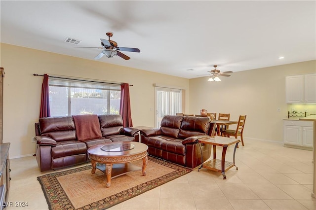 living room with ceiling fan and light tile patterned flooring