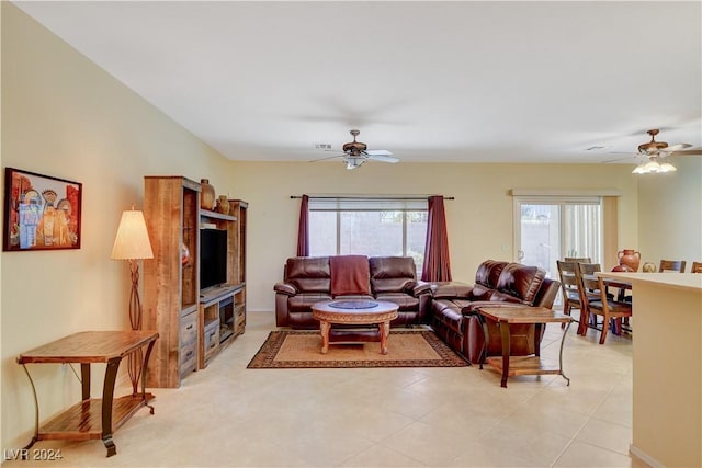 tiled living room featuring ceiling fan