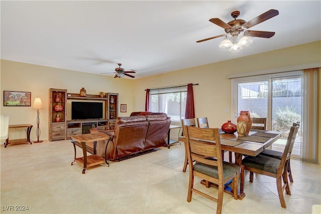 dining space with ceiling fan and light tile patterned flooring