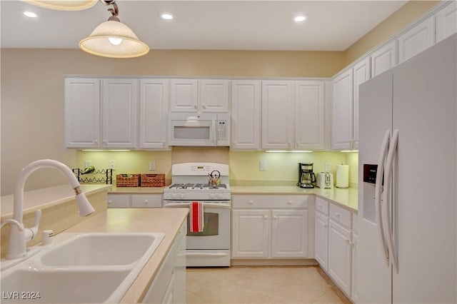 kitchen with sink, light tile patterned floors, decorative light fixtures, white appliances, and white cabinets